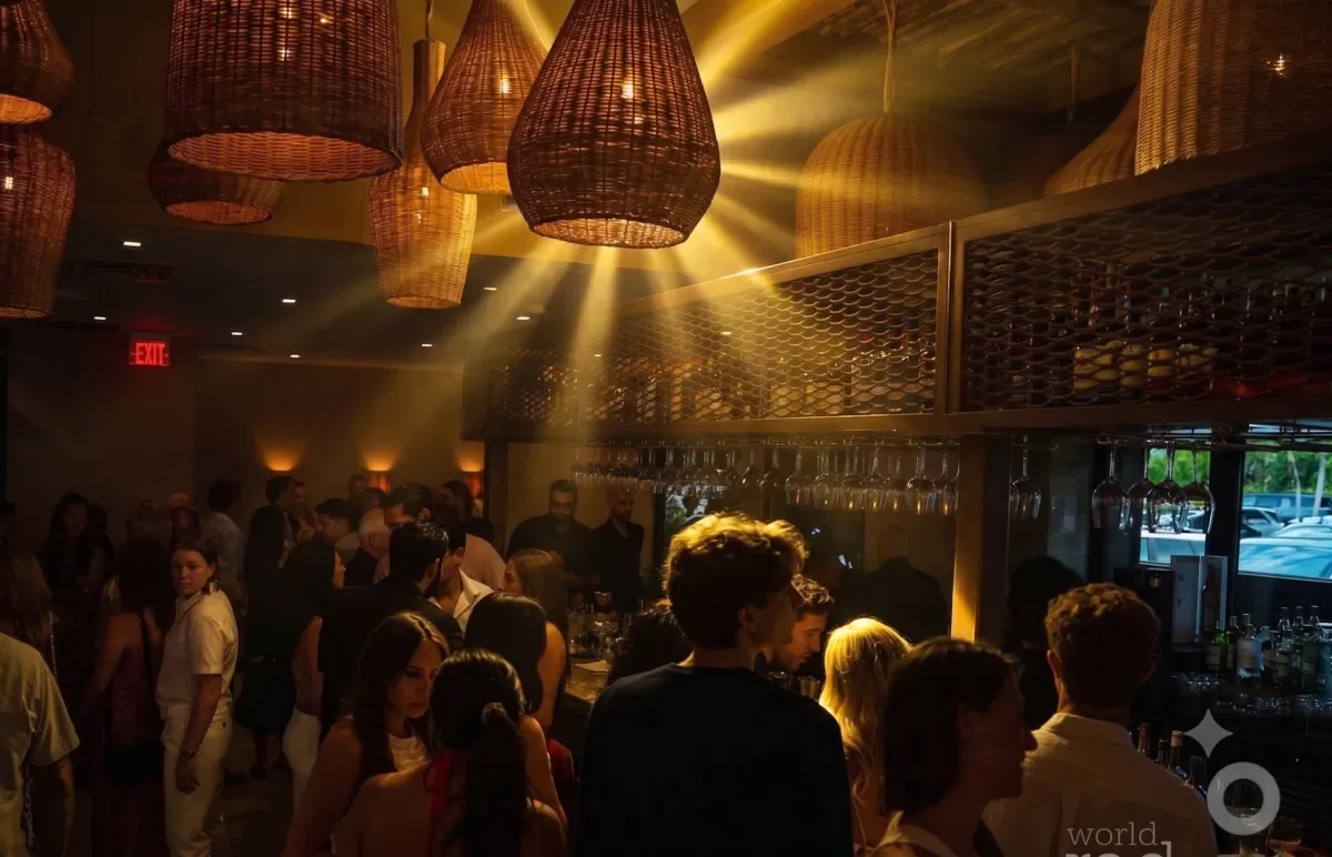 A full room of guests under woven pendant lamps at an Aztechy dinner party