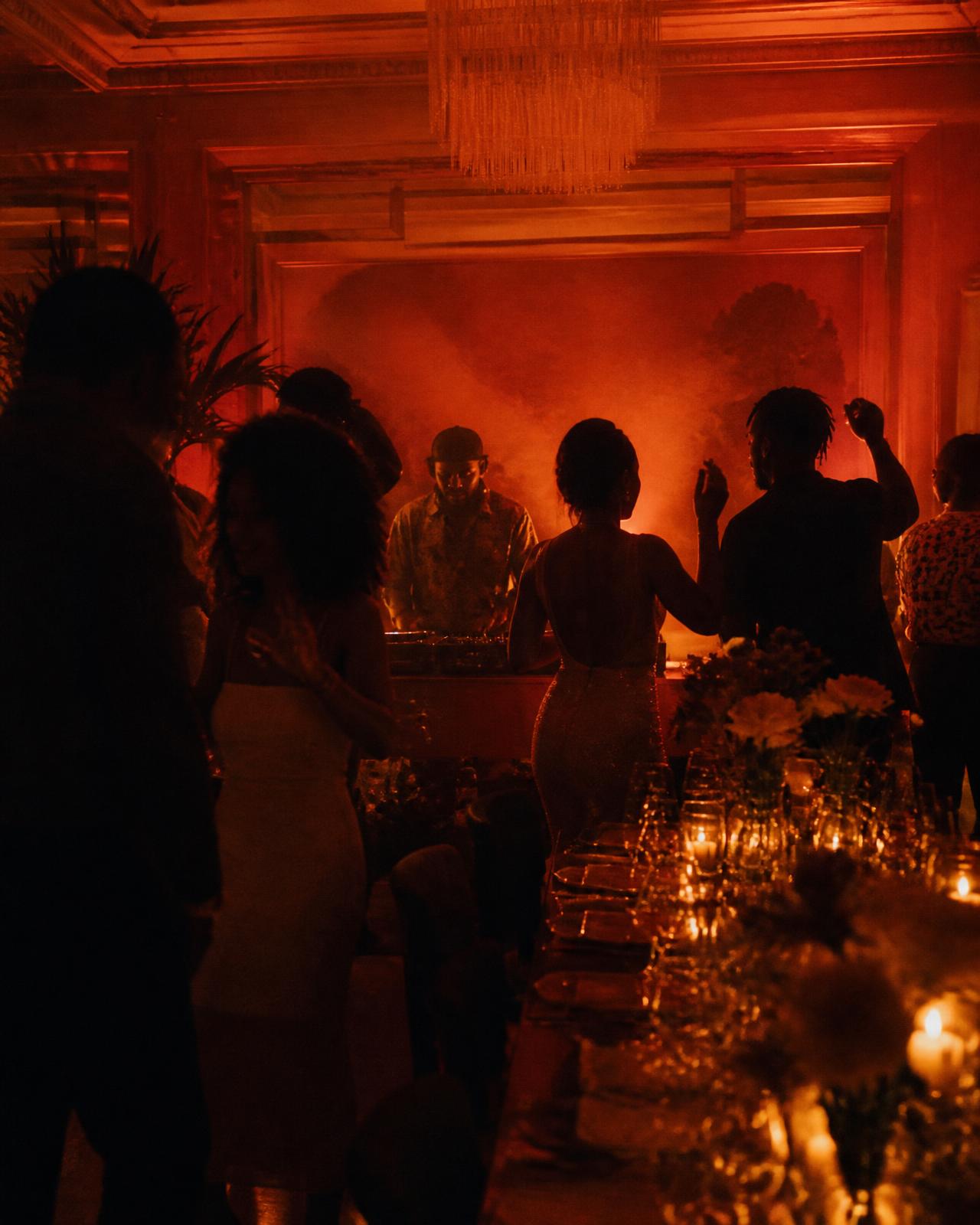 Guests dancing beside the table as the DJ plays